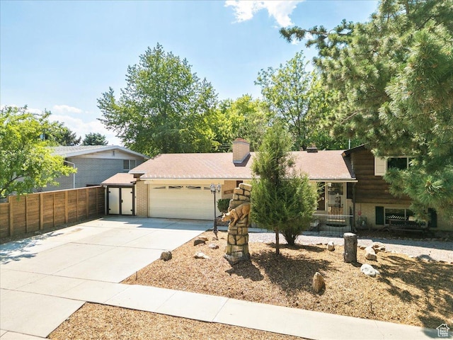 6690 S 1495 E, Cottonwood Heights, UT 84121 - tri-level home with a garage, concrete driveway, and a chimney
