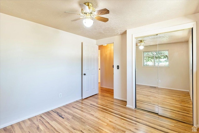 6690 S 1495 E, Cottonwood Heights, UT 84121 - unfurnished bedroom with a closet, light wood-type flooring, a textured ceiling, and a ceiling fan