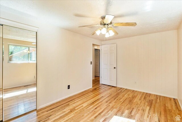 6690 S 1495 E, Cottonwood Heights, UT 84121 - unfurnished room featuring light wood finished floors, ceiling fan, and a textured ceiling