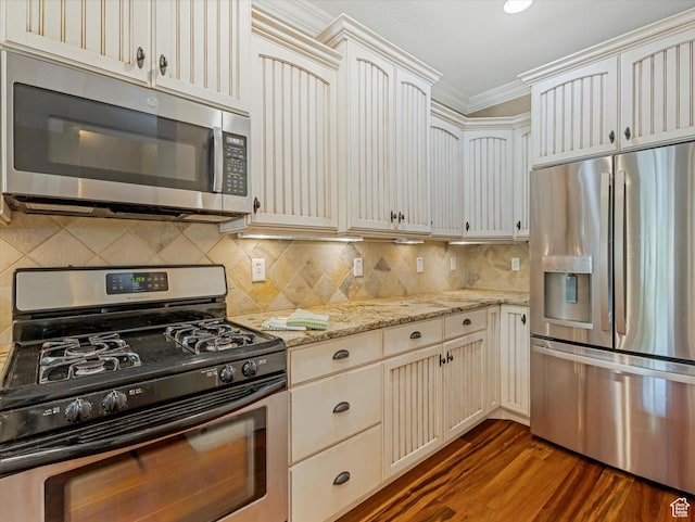 4828 Brooks Way, Holladay, UT 84117 - kitchen with appliances with stainless steel finishes, ornamental molding, dark wood finished floors, light stone counters, and cream cabinetry