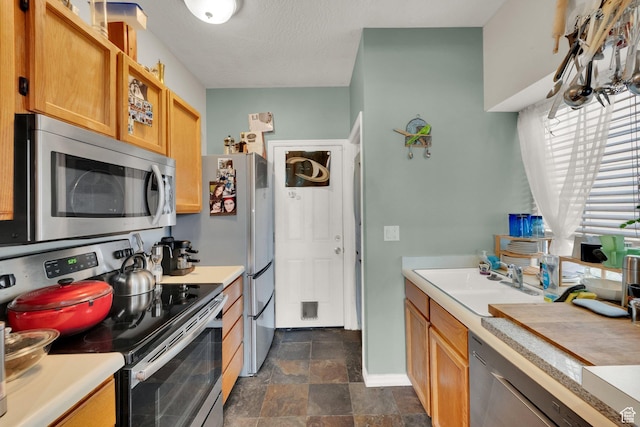 1380 W Ocean Ct, Salt Lake City, UT 84123 - kitchen featuring stainless steel appliances, light countertops, and stone finish flooring