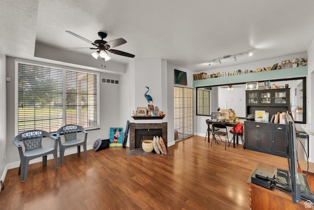 1380 W Ocean Ct, Salt Lake City, UT 84123 - living area featuring ceiling fan, a textured ceiling, wood finished floors, a premium fireplace, and a desk