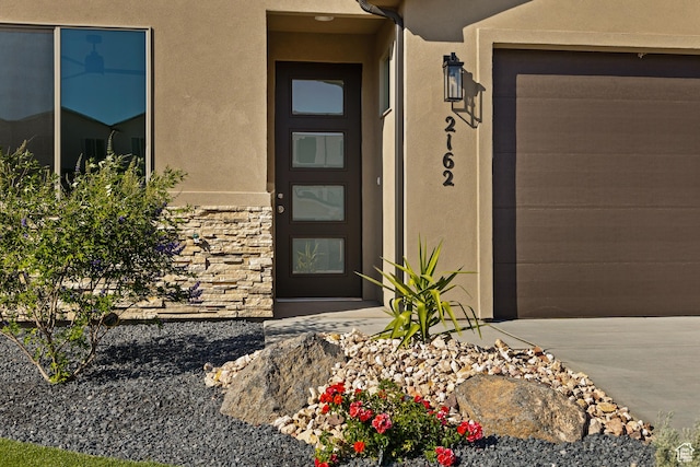 2162 W 320 S Unit 51, Hurricane, UT 84737 - view of exterior entry featuring stucco siding and an attached garage