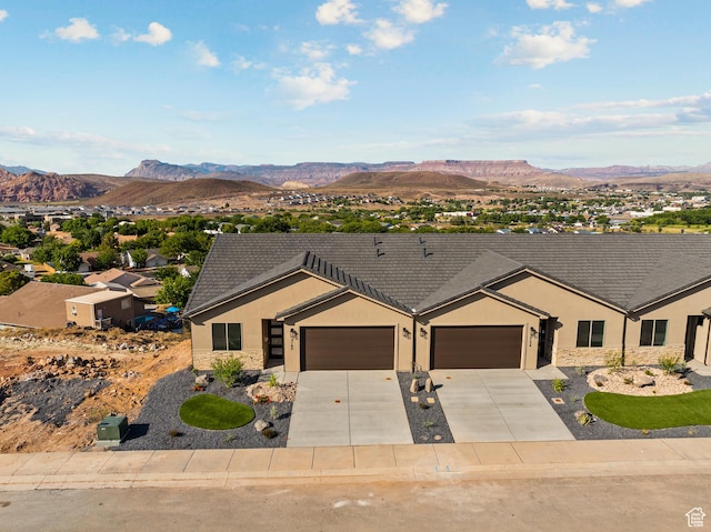 2162 W 320 S Unit 51, Hurricane, UT 84737 - ranch-style house with stucco siding, an attached garage, a mountain view, and driveway