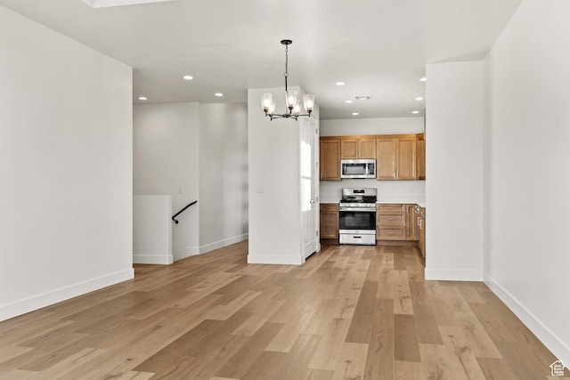 2162 W 320 S Unit 51, Hurricane, UT 84737 - kitchen with stainless steel appliances, light wood finished floors, a chandelier, recessed lighting, and light countertops