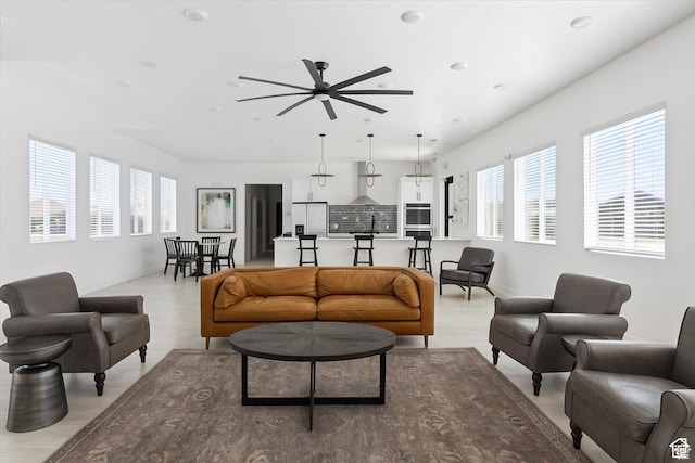 1128 E Bearing Dr S, Saratoga Springs, UT 84045 - living room with light wood finished floors, plenty of natural light, a ceiling fan, and recessed lighting