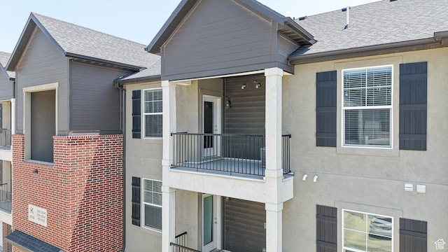 3715 W 1480 N Unit 303, Lehi, UT 84043 - exterior space featuring a balcony, roof with shingles, and stucco siding