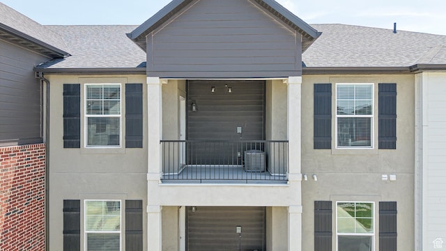 3715 W 1480 N Unit 303, Lehi, UT 84043 - view of front of home featuring a balcony, a shingled roof, and stucco siding
