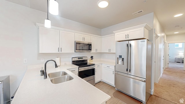 3715 W 1480 N Unit 303, Lehi, UT 84043 - kitchen with stainless steel appliances, white cabinets, light countertops, pendant lighting, and light wood-style floors