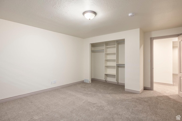 5689 W Sandy Stone Cir S, South Jordan, UT 84009 - unfurnished bedroom featuring carpet floors, a textured ceiling, and a closet
