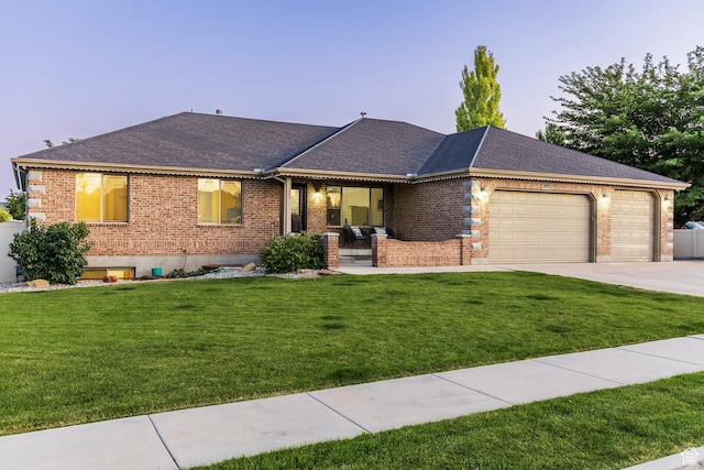5689 W Sandy Stone Cir S, South Jordan, UT 84009 - ranch-style house with brick siding, a garage, driveway, a front lawn, and a shingled roof
