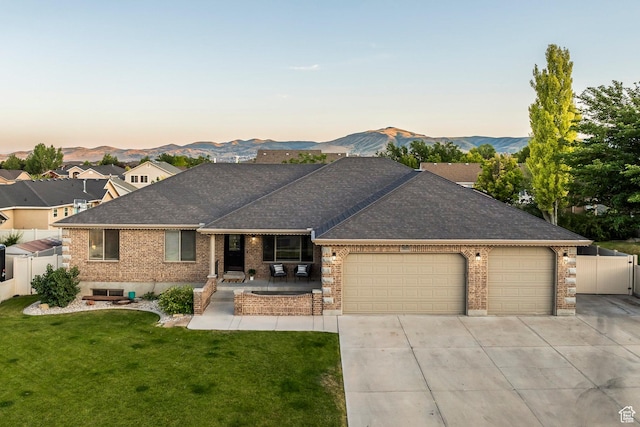 5689 W Sandy Stone Cir S, South Jordan, UT 84009 - ranch-style house featuring roof with shingles, brick siding, an attached garage, and driveway