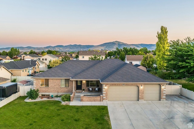 5689 W Sandy Stone Cir S, South Jordan, UT 84009 - ranch-style home featuring a garage, brick siding, driveway, a mountain view, and a fenced backyard