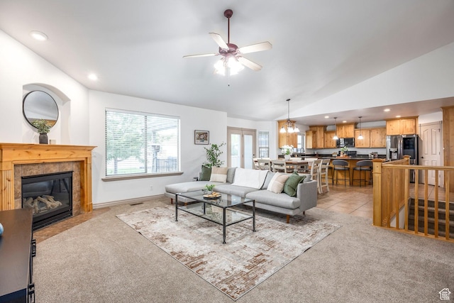 5689 W Sandy Stone Cir S, South Jordan, UT 84009 - living area featuring light colored carpet, lofted ceiling, ceiling fan, a tile fireplace, and a chandelier