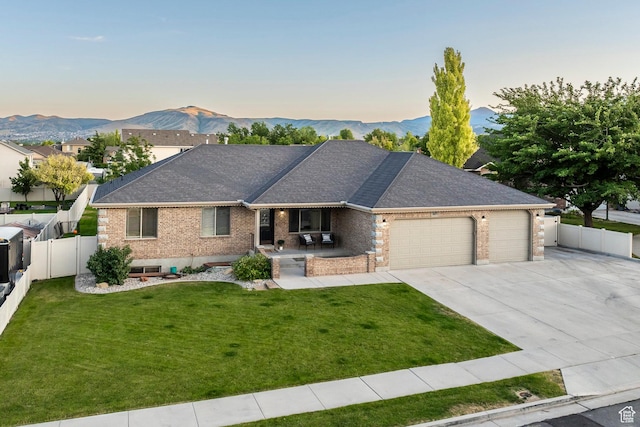 5689 W Sandy Stone Cir S, South Jordan, UT 84009 - single story home with brick siding, a garage, covered porch, and a mountain view