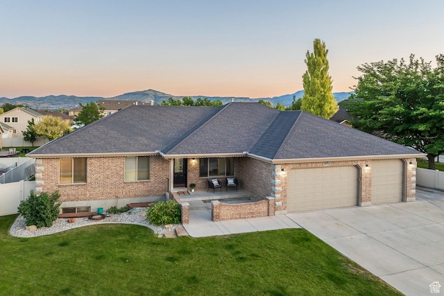 5689 W Sandy Stone Cir S, South Jordan, UT 84009 - ranch-style home with brick siding, an attached garage, concrete driveway, roof with shingles, and a mountain view