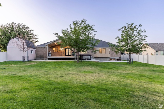 5689 W Sandy Stone Cir S, South Jordan, UT 84009 - back of house featuring a deck, a patio area, a storage unit, and brick siding