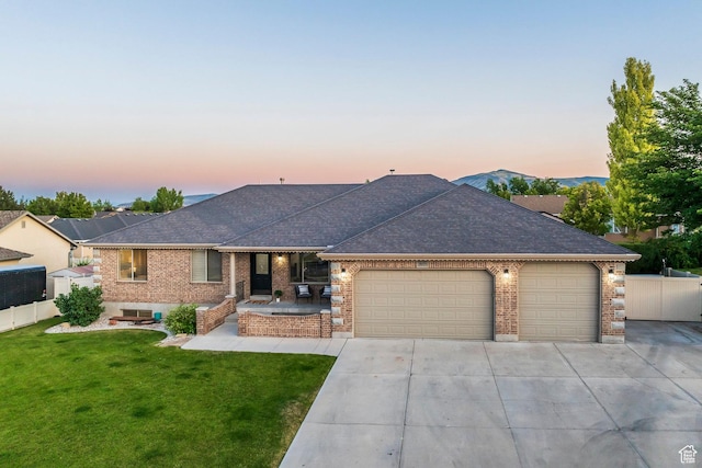 5689 W Sandy Stone Cir S, South Jordan, UT 84009 - view of front facade featuring a garage, brick siding, and a shingled roof