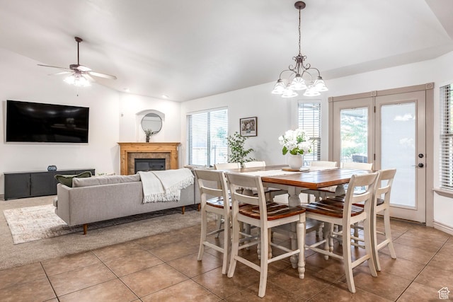 5689 W Sandy Stone Cir S, South Jordan, UT 84009 - dining room featuring light tile patterned floors, a glass covered fireplace, a chandelier, ceiling fan, and vaulted ceiling