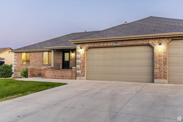 5689 W Sandy Stone Cir S, South Jordan, UT 84009 - ranch-style home featuring brick siding, driveway, a garage, and roof with shingles