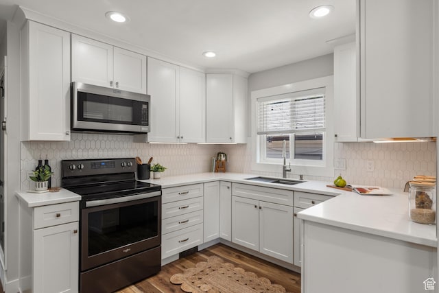4621 S 150 W, Washington Terrace, UT 84405 - kitchen featuring stainless steel appliances, white cabinets, wood finished floors, light countertops, and backsplash