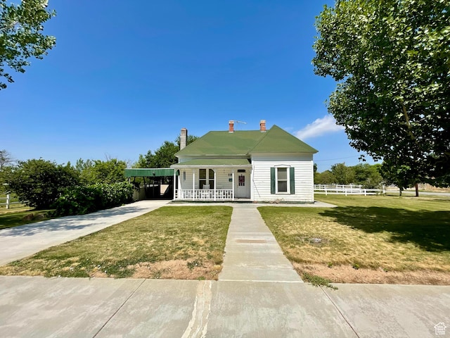 12 S Main, Holden, UT 84636 - view of front of home featuring a chimney, covered porch, concrete driveway, and a carport