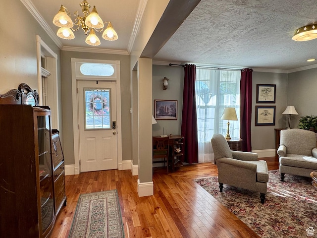 12 S Main, Holden, UT 84636 - entryway featuring healthy amount of natural light, light wood finished floors, a chandelier, and ornamental molding