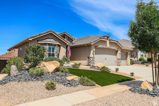 621 N Sage Hen Dr, Washington, UT 84780 - single story home with an attached garage, stone siding, concrete driveway, and a tiled roof