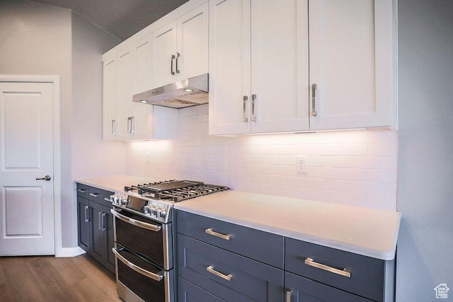 621 N Sage Hen Dr, Washington, UT 84780 - kitchen with under cabinet range hood, double oven range, white cabinetry, and tasteful backsplash