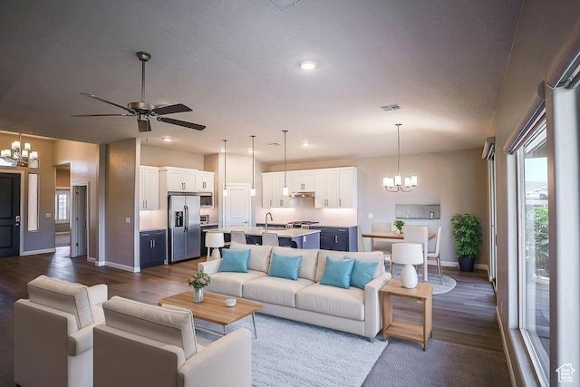 621 N Sage Hen Dr, Washington, UT 84780 - living room with a chandelier, dark wood-type flooring, a ceiling fan, recessed lighting, and a textured ceiling
