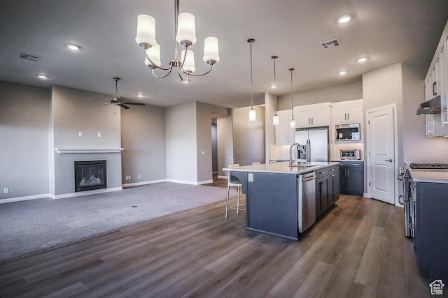 621 N Sage Hen Dr, Washington, UT 84780 - kitchen featuring stainless steel appliances, ceiling fan, light countertops, dark wood-type flooring, and recessed lighting