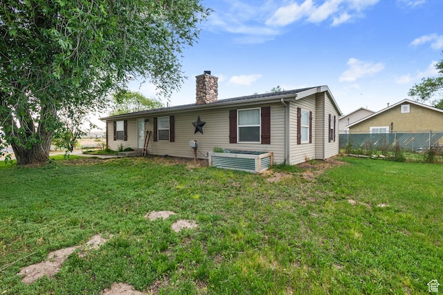 7194 W Schuler Ave, West Valley City, UT 84128 - rear view of property with a chimney