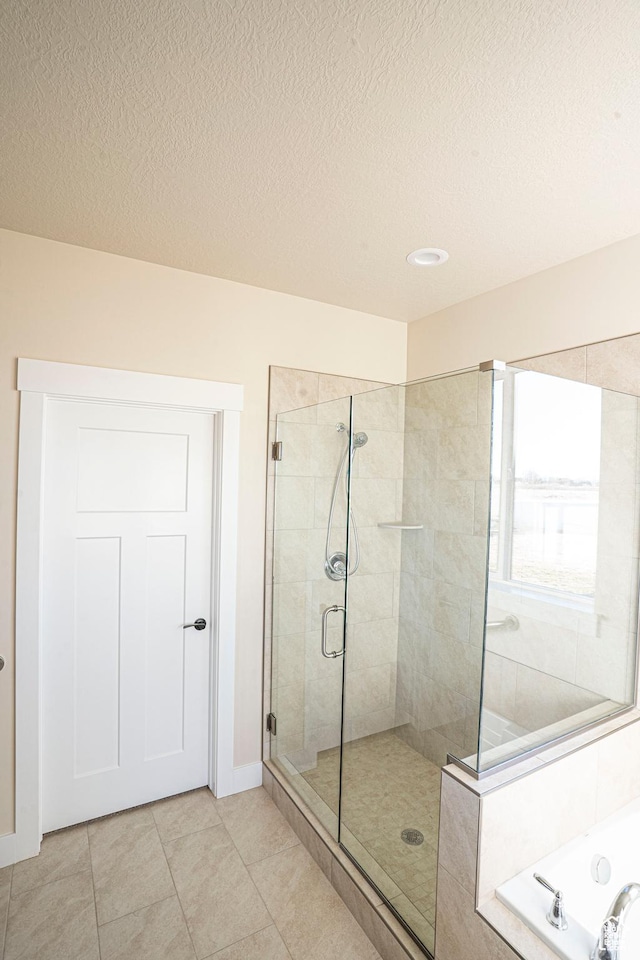 3966 W 2025 S Unit 29, Taylor, UT 84401 - bathroom with a shower stall, a garden tub, tile patterned floors, a textured ceiling, and recessed lighting