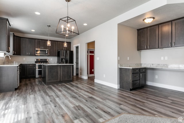 4567 W Breezy Meadow Dr, Herriman, UT 84096 - kitchen featuring appliances with stainless steel finishes, dark brown cabinetry, light countertops, wood finished floors, and recessed lighting