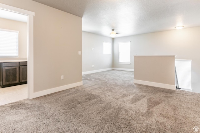 4567 W Breezy Meadow Dr, Herriman, UT 84096 - unfurnished room with light carpet and a textured ceiling
