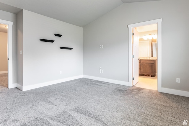 4567 W Breezy Meadow Dr, Herriman, UT 84096 - unfurnished bedroom featuring carpet, vaulted ceiling, and connected bathroom