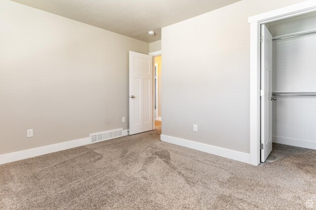 4567 W Breezy Meadow Dr, Herriman, UT 84096 - unfurnished bedroom with carpet, a closet, and a walk in closet