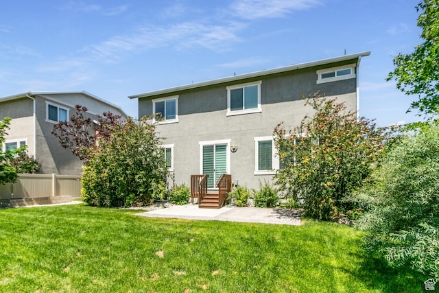 4567 W Breezy Meadow Dr, Herriman, UT 84096 - back of house featuring stucco siding and a patio