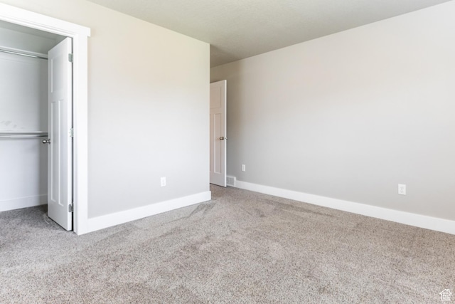 4567 W Breezy Meadow Dr, Herriman, UT 84096 - unfurnished bedroom featuring carpet flooring, a closet, and a walk in closet