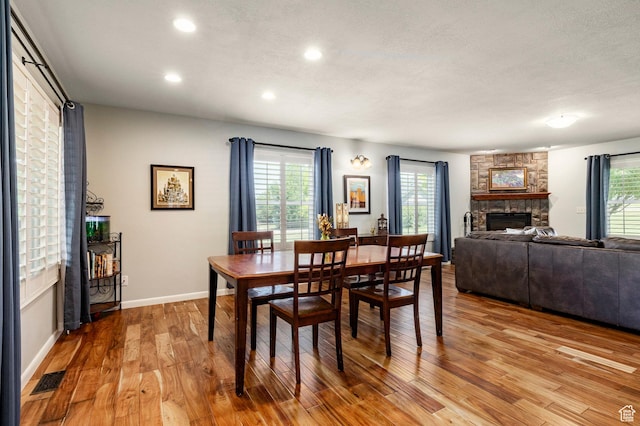8871 S 100 E, Paradise, UT 84328 - dining room featuring a stone fireplace, light wood finished floors, and recessed lighting