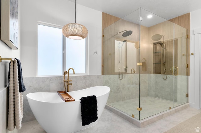 6809 W Vista Springs Dr, Herriman, UT 84096 - bathroom featuring a shower stall, a freestanding tub, healthy amount of natural light, and tile walls