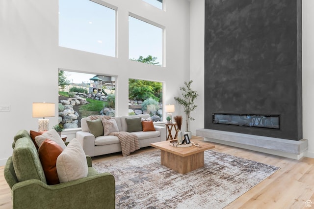 6809 W Vista Springs Dr, Herriman, UT 84096 - living room with a high ceiling, a large fireplace, and wood finished floors