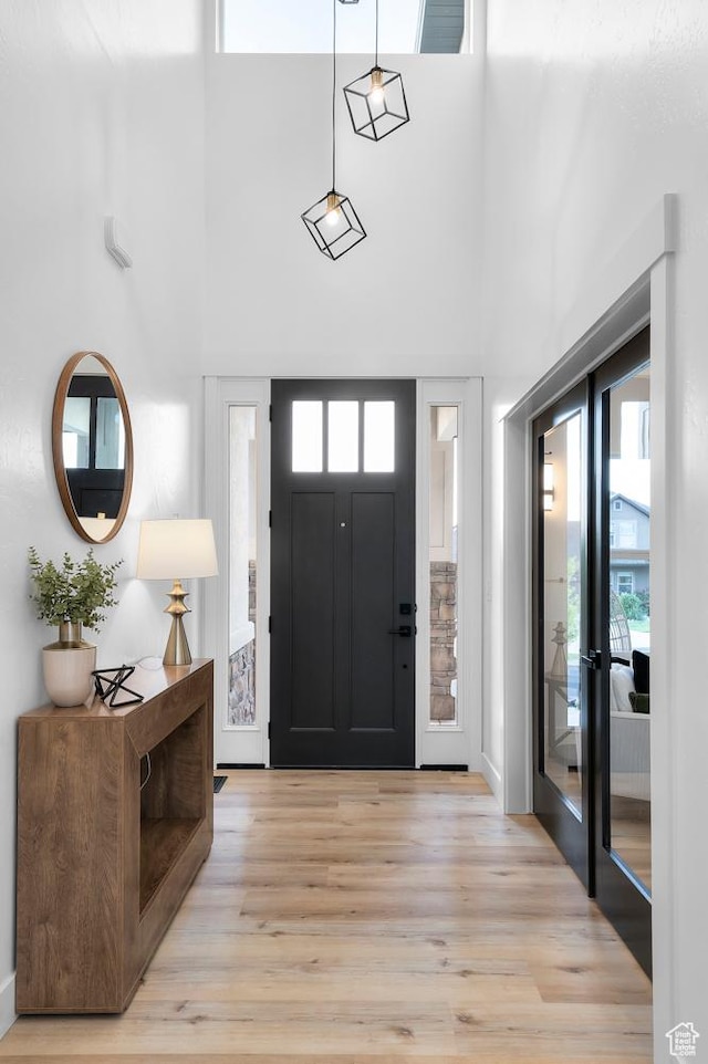 6809 W Vista Springs Dr, Herriman, UT 84096 - foyer featuring light wood-style floors, a towering ceiling, and french doors