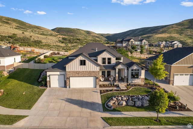 6809 W Vista Springs Dr, Herriman, UT 84096 - view of front facade with board and batten siding, stone siding, a mountain view, driveway, and a residential view