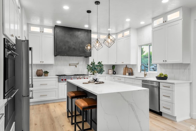 6809 W Vista Springs Dr, Herriman, UT 84096 - kitchen featuring range hood, appliances with stainless steel finishes, a kitchen island, decorative backsplash, and recessed lighting