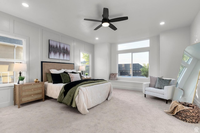 6809 W Vista Springs Dr, Herriman, UT 84096 - bedroom featuring light carpet, multiple windows, a decorative wall, recessed lighting, and a ceiling fan