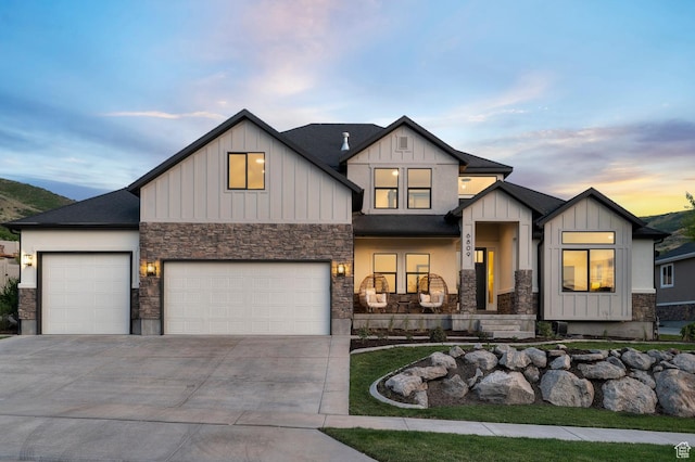 6809 W Vista Springs Dr, Herriman, UT 84096 - view of front of home with stone siding, board and batten siding, concrete driveway, and a porch