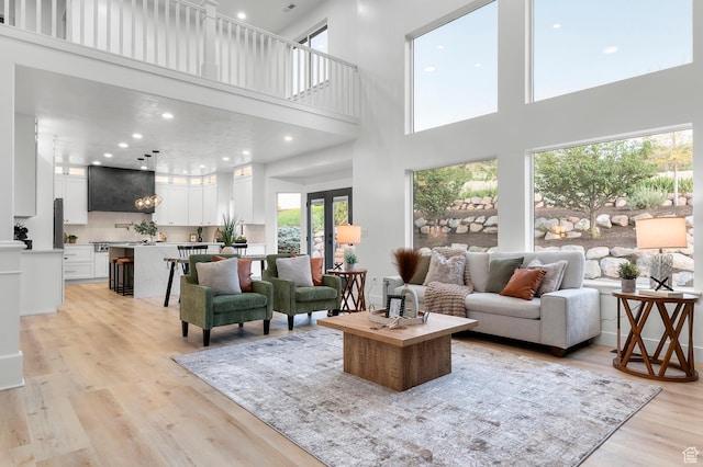 6809 W Vista Springs Dr, Herriman, UT 84096 - living area featuring a high ceiling, light wood-style flooring, french doors, and recessed lighting
