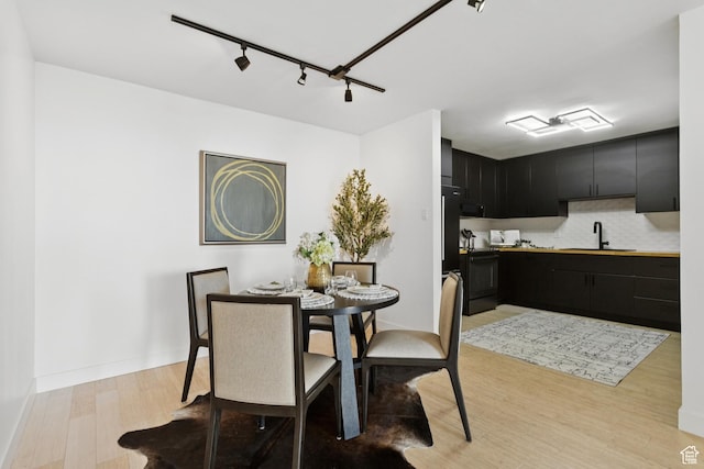 123 E 2nd Ave Unit 505, Salt Lake City, UT 84103 - dining room featuring light wood finished floors and rail lighting