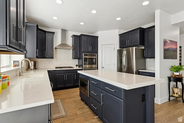 319 S 300 E, Midway, UT 84049 - kitchen with appliances with stainless steel finishes, wall chimney exhaust hood, decorative backsplash, a center island, and recessed lighting